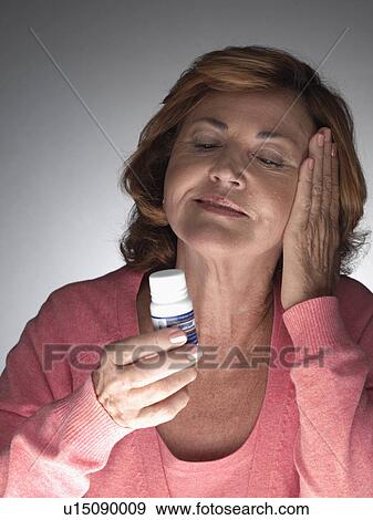 Mature woman taking aspirin View Large Photo Image Stock Photo - Mature woman taking aspirin. Fotosearch