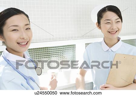 Portrait of two nurses, twin sisters, smiling and looking at camera, front view, side view View Large Photo Image Stock Image - Portrait of two nurses, twin sisters, smiling and looking at camera, front view, side view. Fotosearch