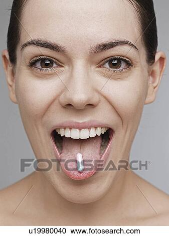 Vitamin pill on young woman's tongue View Large Photo Image Stock Image - Vitamin pill on young woman's tongue. Fotosearch