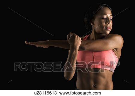 African American young adult woman in sports bra stretching arms with eyes closed. View Large Photo Image Stock Image - African American young adult woman in sports bra stretching arms with eyes closed.. Fotosearch