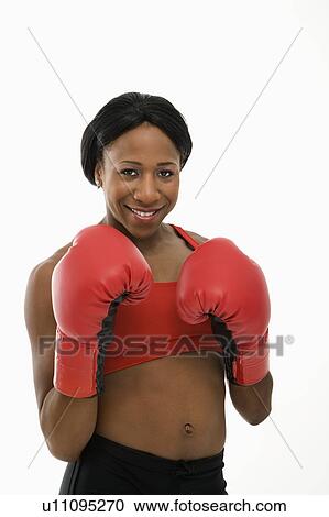 African American young adult woman wearing boxing goves smiling at viewer. View Large Photo Image Stock Image - African American young adult woman wearing boxing goves smiling at viewer.. Fotosearch