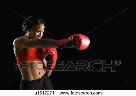 African American young adult woman wearing boxing gloves throwing punch. View Large Photo Image Stock Image - African American young adult woman wearing boxing gloves throwing punch.. Fotosearch