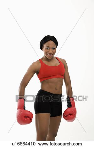 African American young adult woman wearing boxing goves smiling at viewer. View Large Photo Image Stock Image - African American young adult woman wearing boxing goves smiling at viewer.. Fotosearch