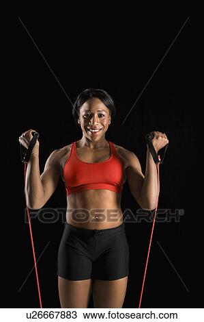 African American young adult woman exercising with resistance tube and smiling at viewer. View Large Photo Image Stock Image - African American young adult woman exercising with resistance tube and smiling at viewer.. Fotosearch