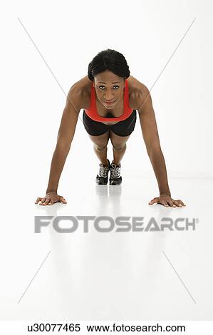 African American young adult woman doing push up and looking at viewer. View Large Photo Image Stock Photography - African American young adult woman doing push up and looking at viewer.. Fotosearch