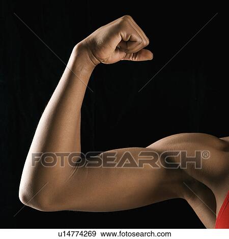 Arm of African American woman flexing muscular bicep. View Large Photo Image Stock Photo - Arm of African American woman flexing muscular bicep.. Fotosearch