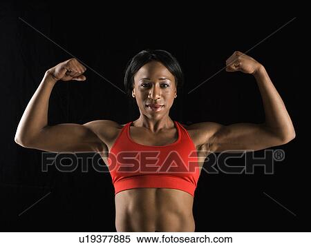 Muscular African American woman looking at viewer with biceps flexed. View Large Photo Image Stock Photography - Muscular African American woman looking at viewer with biceps flexed.. Fotosearch