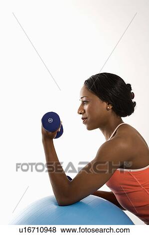 Profile of African American young adult woman leaning on exercise ball holding dumbbell. View Large Photo Image Stock Photo - Profile of African American young adult woman leaning on exercise ball holding dumbbell.. Fotosearch