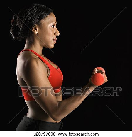 Profile of African American young adult woman lifting dumbbell. View Large Photo Image Stock Photo - Profile of African American young adult woman lifting dumbbell.. Fotosearch