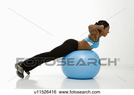 Profile of African American young adult woman working out with exercise ball. View Large Photo Image Stock Photograph - Profile of African American young adult woman working out with exercise ball.. Fotosearch