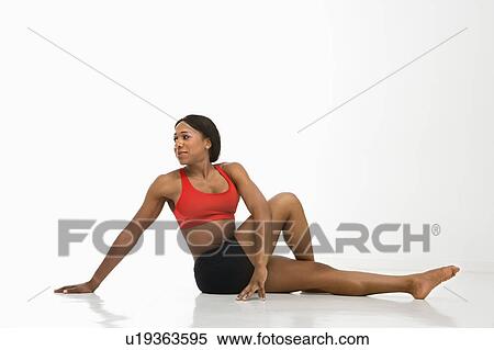 Profile of African American young adult woman stretching on floor. View Large Photo Image Stock Photography - Profile of African American young adult woman stretching on floor.. Fotosearch