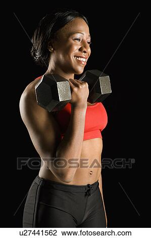 Smiling African American young adult woman holding dumbbell. View Large Photo Image Stock Image - Smiling African American young adult woman holding dumbbell.. Fotosearch