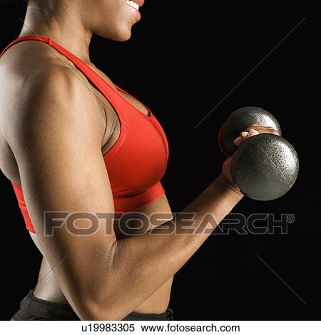 Torso of African American young adult woman lifting dumbbell. View Large Photo Image Stock Photography - Torso of African American young adult woman lifting dumbbell.. Fotosearch