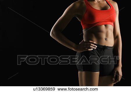 Torso of muscular African American woman wearing athletic apparel with hand on hip. View Large Photo Image Stock Photo - Torso of muscular African American woman wearing athletic apparel with hand on hip.. Fotosearch