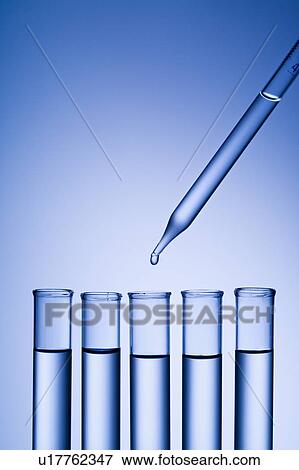 Dropper dropping liquid into test tube. View Large Photo Image Stock Photo - Dropper dropping liquid into test tube.. Fotosearch