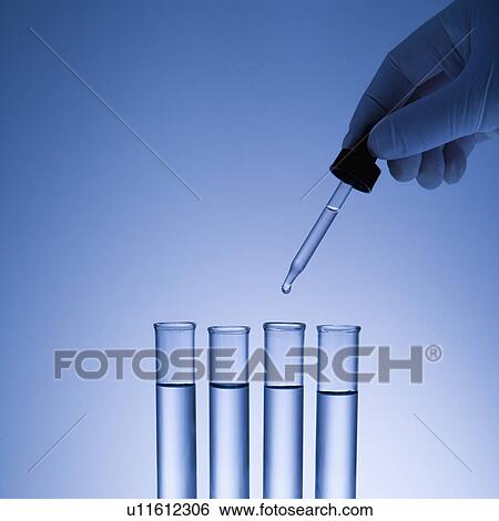 Hand holding dropper over test tubes. View Large Photo Image Stock Photograph - Hand holding dropper over test tubes.. Fotosearch