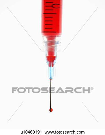 Stock Image - Hypodermic needle filled with red liquid.. Fotosearch