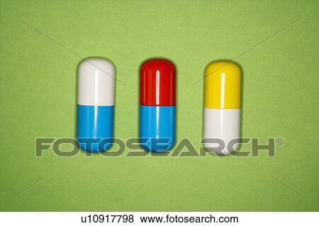 Stock Photo - Medical pills on a green background.. Fotosearch