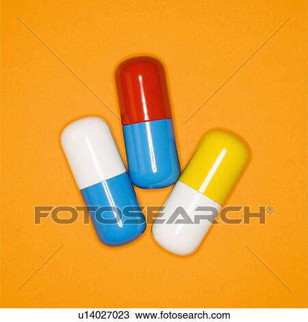 Medical pills on a orange background. View Large Photo Image Stock Image - Medical pills on a orange background.. Fotosearch