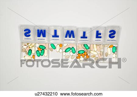 Stock Image - Weekly container with pills and vitamins.. Fotosearch