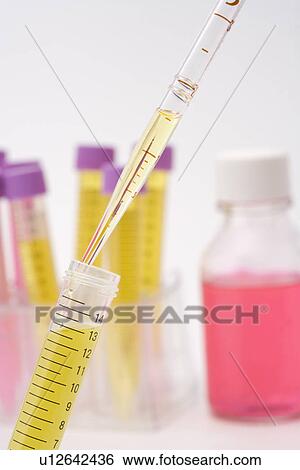 Stock Photograph - Injecting liquid into a test tube, Differential Focus. Fotosearch