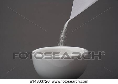 Stock Photograph - Inserting medicine into mortar. Fotosearch