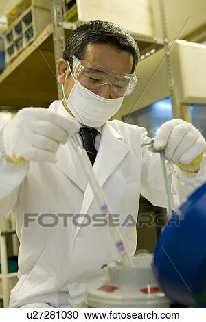 Mature scientist man conducting experiment in laboratory, low angle view View Large Photo Image Stock Image - Mature scientist man conducting experiment in laboratory, low angle view. Fotosearch