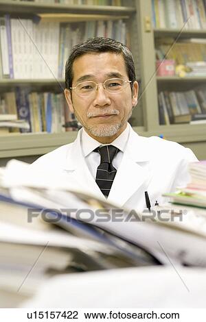 Stock Image - Portrait of a mature scientist man, front view, Differential Focus. Fotosearch