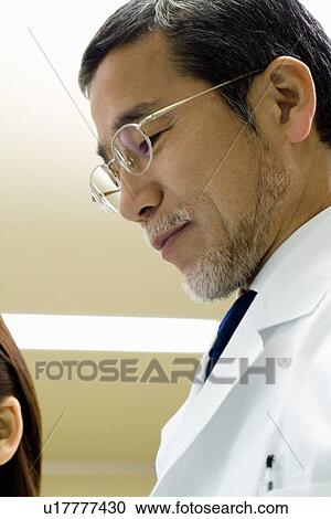 Two scientists talking in laboratory in laboratory, close up, low angle view View Large Photo Image Stock Image - Two scientists talking in laboratory in laboratory, close up, low angle view. Fotosearch