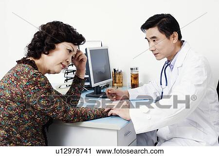 Close-up of a doctor examining a female patient View Large Photo Image Stock Image - Close-up of a doctor examining a female patient. Fotosearch