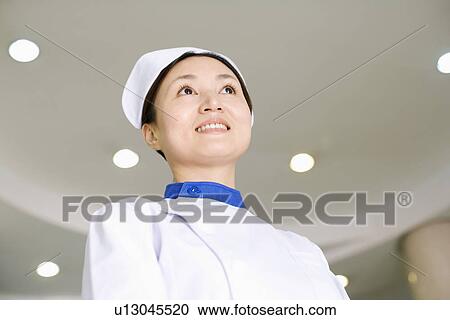Close-up of a female nurse smiling View Large Photo Image Stock Image - Close-up of a female nurse smiling. Fotosearch