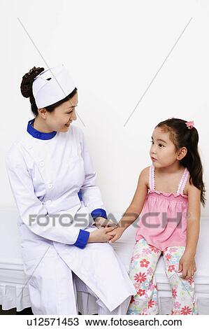 Female nurse holding a girl's hand View Large Photo Image Stock Image - Female nurse holding a girl's hand. Fotosearch