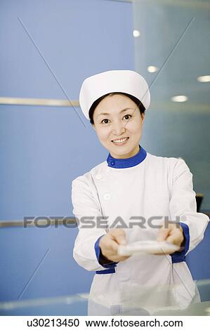 Portrait of a female nurse smiling View Large Photo Image Stock Image - Portrait of a female nurse smiling. Fotosearch