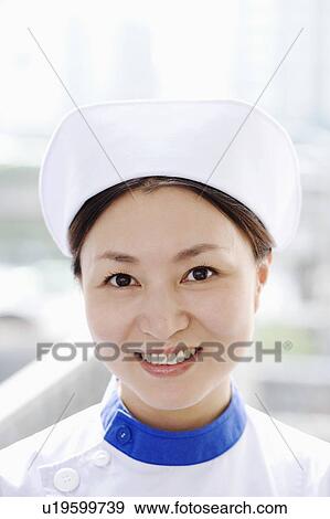 Stock Photo - Portrait of a female nurse smiling. Fotosearch