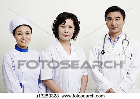 Stock Photo - Portrait of a male doctor and a female doctor with a female nurse. Fotosearch