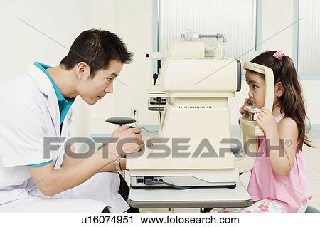 Side profile of an optometrist examining a patient View Large Photo Image Stock Image - Side profile of an optometrist examining a patient. Fotosearch