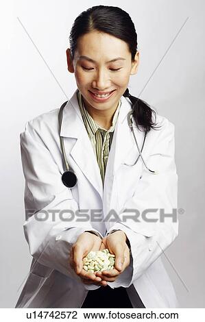 Close-up of a female doctor holding tablets View Large Photo Image Stock Image - Close-up of a female doctor holding tablets. Fotosearch
