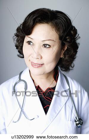 Close-up of a female doctor smiling View Large Photo Image Stock Photo - Close-up of a female doctor smiling. Fotosearch