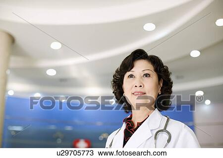 Close-up of a female doctor with a stethoscope around her neck View Large Photo Image Stock Image - Close-up of a female doctor with a stethoscope around her neck. Fotosearch