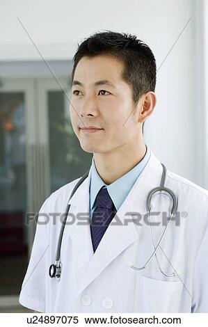 Close-up of a male doctor looking away View Large Photo Image Stock Photography - Close-up of a male doctor looking away. Fotosearch