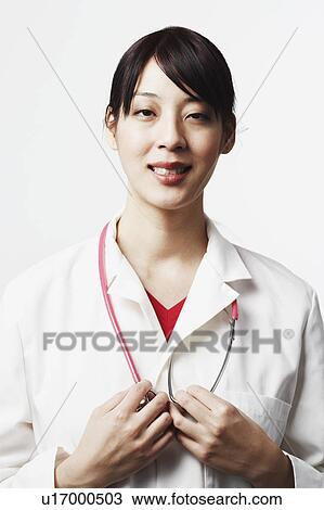 Portrait of a female doctor smiling View Large Photo Image Stock Image - Portrait of a female doctor smiling. Fotosearch