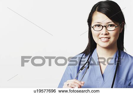 Stock Photograph - Portrait of a female doctor smiling. Fotosearch