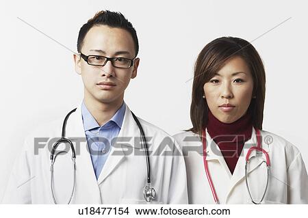 Portrait of a male and a female doctor standing side by side View Large Photo Image Picture - Portrait of a male and a female doctor standing side by side. Fotosearch