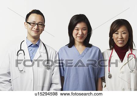 Portrait of a male and a female doctor with a female nurse standing side by side View Large Photo Image Stock Photo - Portrait of a male and a female doctor with a female nurse standing side by side. Fotosearch