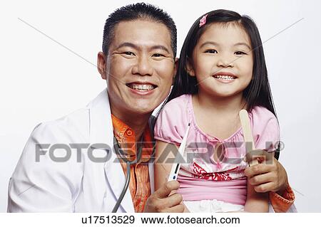 Portrait of a male doctor and his patient smiling View Large Photo Image Stock Photo - Portrait of a male doctor and his patient smiling. Fotosearch