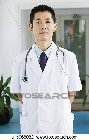 Portrait of a male doctor standing View Large Photo Image Stock Image - Portrait of a male doctor standing. Fotosearch