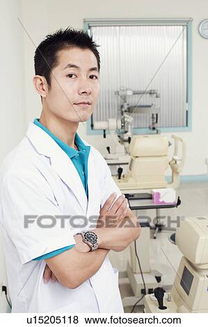 Portrait of a male doctor standing with his arms crossed View Large Photo Image Stock Photo - Portrait of a male doctor standing with his arms crossed. Fotosearch