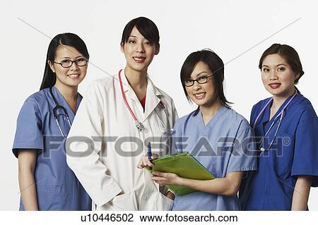 Stock Image - Portrait of four female doctors standing together. Fotosearch