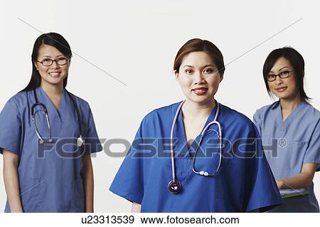 Portrait of three female doctors smiling View Large Photo Image Stock Photo - Portrait of three female doctors smiling. Fotosearch
