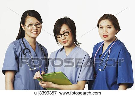 Stock Photo - Portrait of three female doctors standing together. Fotosearch